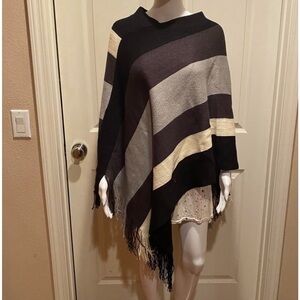 Striped poncho with fringe.